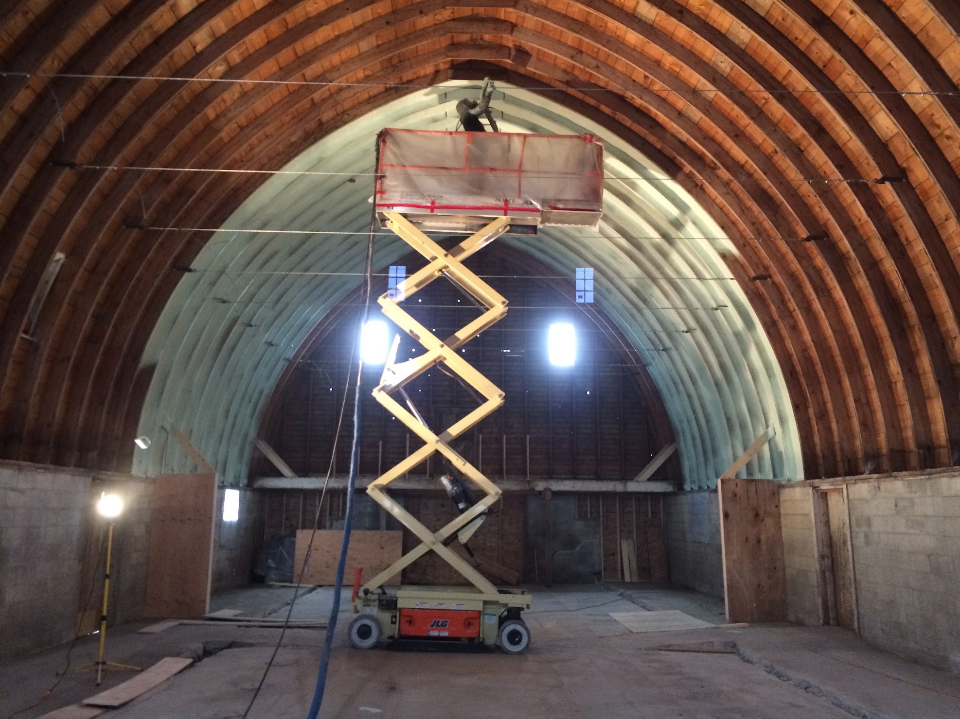 Scissor lift in an arched building ready for spray foam insulation Fargo.