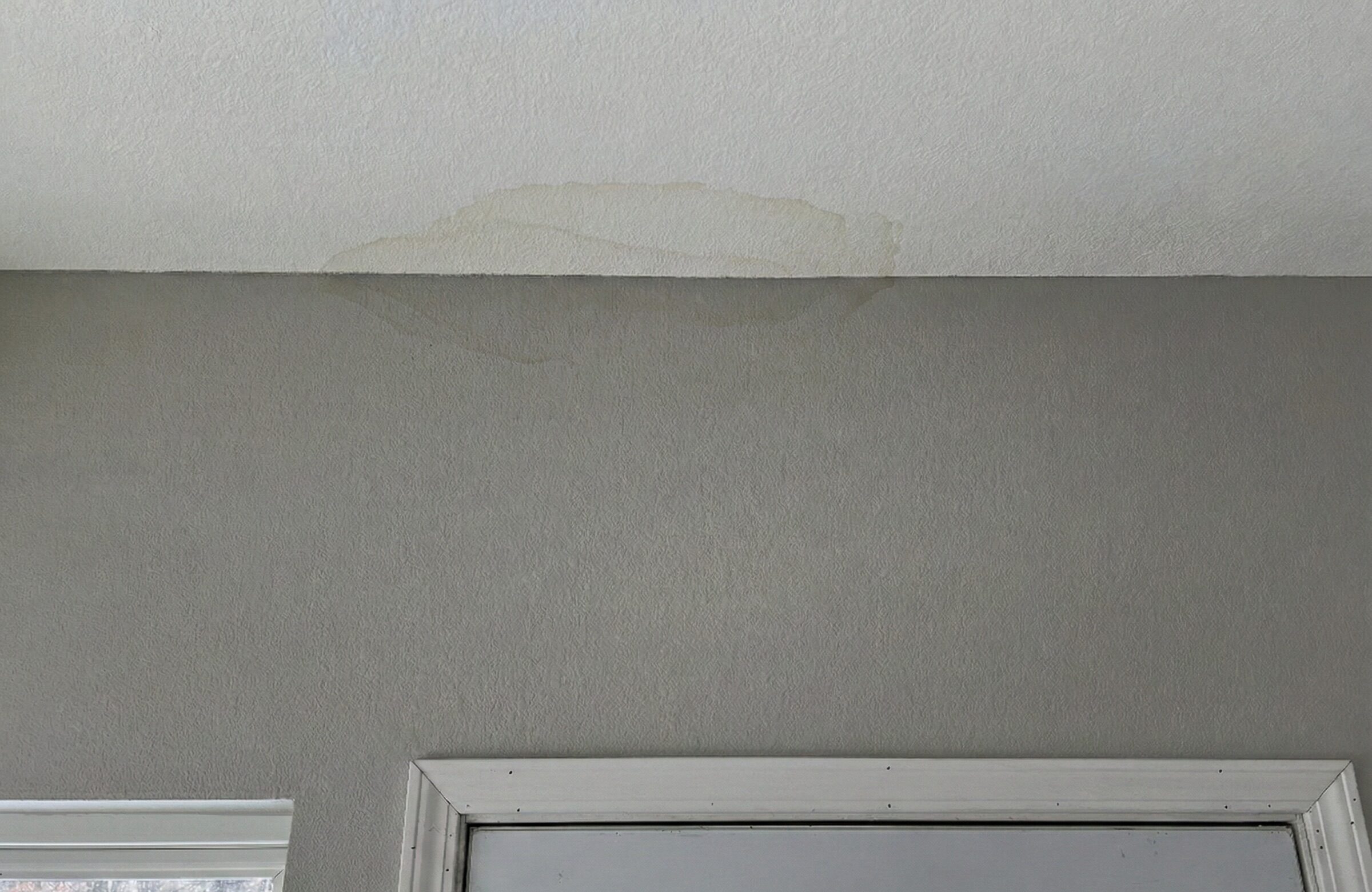 Water stain on a drywall ceiling requiring attic insulation removal Fargo.